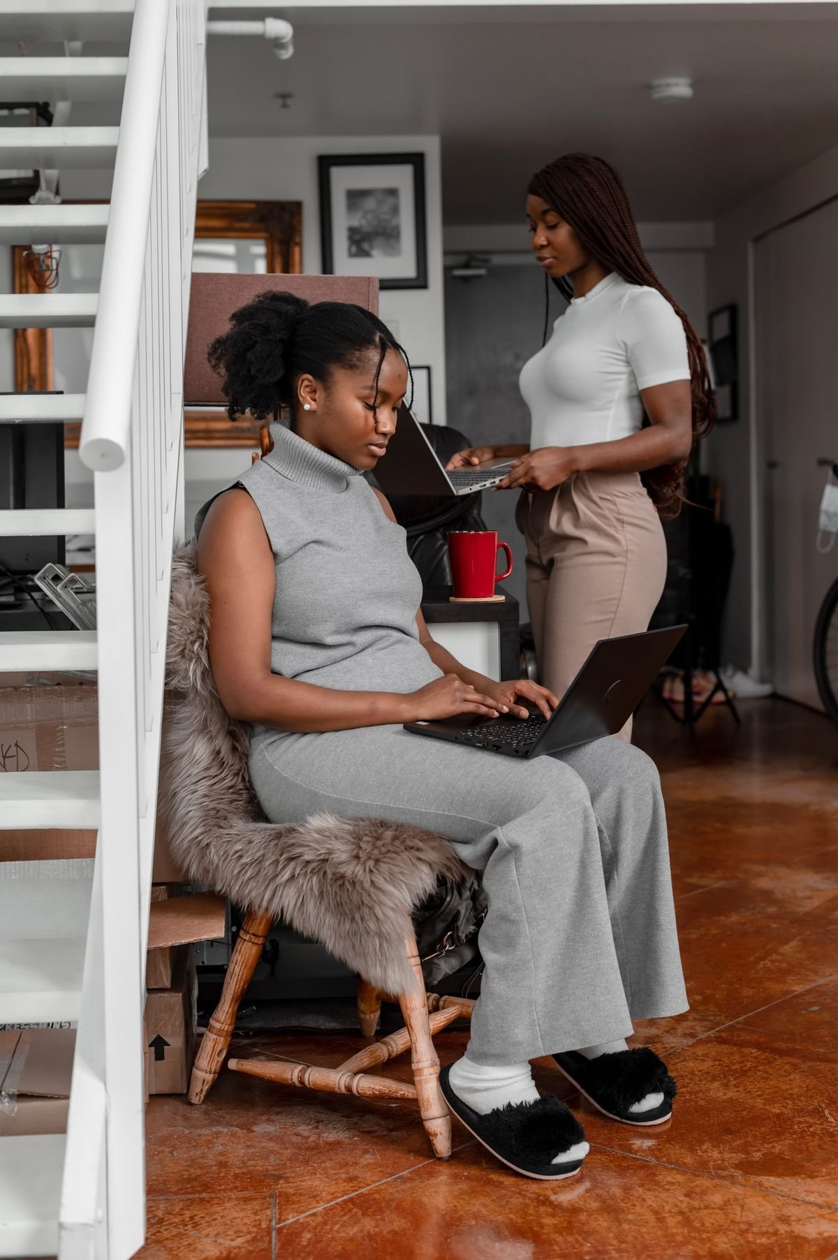 Two young professionals working on laptops
